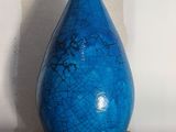 a blue vase sitting on top of a cardboard box