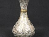 silver and gold vase on a black background with a black background
