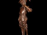 bronze statue of a man holding a spear and a flag
