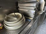 a stack of plates and pans on the counter