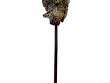 a close up of a sculpture of a head on a metal stand