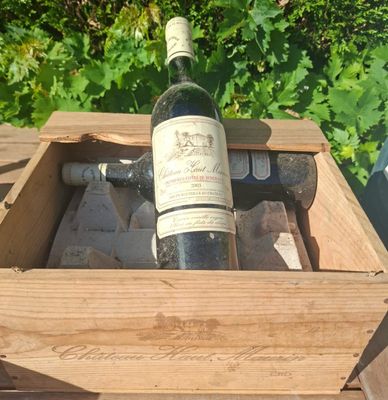 a bottle of wine in a wooden box on a table