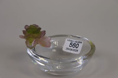 a small glass bowl with a small flower in it
