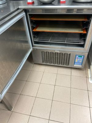a small oven with a lot of food inside of it