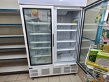 an empty refrigerator in the middle of a grocery store