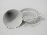 a white cup and saucer sitting on a white table