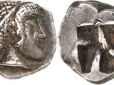 a silver coin with an image of a woman and a man on it