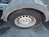 a flat tire on a trailer that is parked on the street