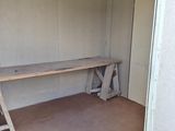 a room that has a bench and a table in it