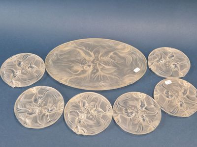 six assiettes en verre transparent ornées de motifs sur un fond bleu