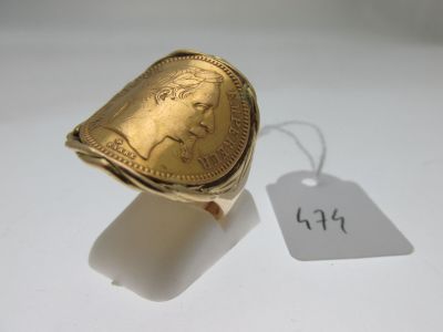 a gold ring with a picture of a woman on it