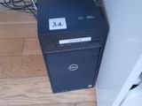 a dell computer sitting on the floor next to a laptop