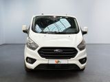 the front of a white ford transit van parked in a showroom