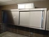 a stainless steel cabinet with a mirror above it
