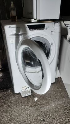 a washer and dryer sitting next to each other on the floor