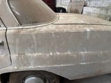 a dirty car that is parked in a garage