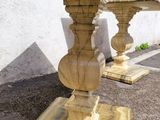 a marble table with two vases on top of it