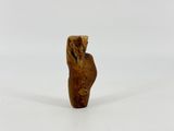 a small wooden figurine of a man with a hat on his head