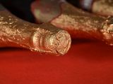 a close up picture of a pair of feet with gold paint on them