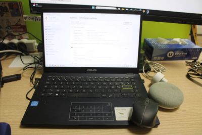 a laptop computer sitting on top of a desk next to a mouse