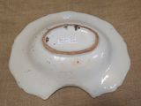 a white bowl with a brown rim sitting on a table