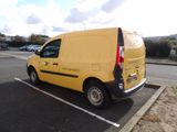 a yellow van that is parked in a parking lot