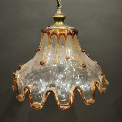 an image of a glass light fixture hanging from a ceiling