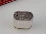 a close up of a small silver object on a table