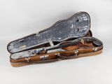 an old violin case that is open on a white background