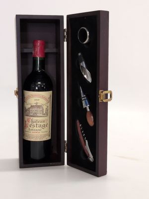a bottle of wine in a wooden case with a cork opener