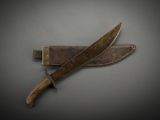 an old knife with a wooden handle sitting on top of a table