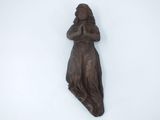 a statue of a woman holding her hands on her chest