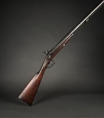 a rifle with a wooden barrel on a black background
