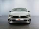 the front of a white volkswagen vw golf parked in a garage