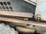 a close up of a rusted metal door and a tire