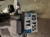 a motorcycle parked in a garage with a license plate on it