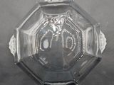 a clear glass bowl with a decorative design on it