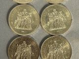 six different british pound coins are shown on a table