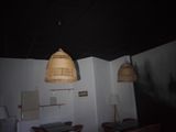 two lamps hanging from the ceiling above a table and chairs