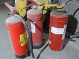several fire extinguisors are lined up in a row next to each other