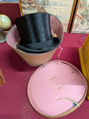 a hat and a clock sitting on a table