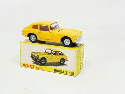 a yellow toy car sitting on top of a box