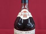 an image of a bottle of wine sitting on a red surface