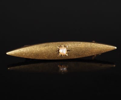 a gold surfboard sitting on top of a black surface