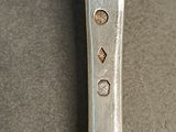 a silver spoon with a silver handle on a table