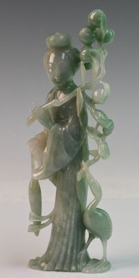 a statue of a woman holding a flower and a bird