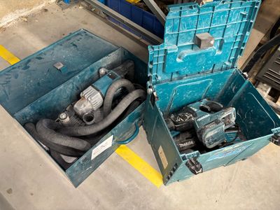 two blue boxes with tools in them sitting on the floor