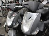 many scooters that are parked in a garage
