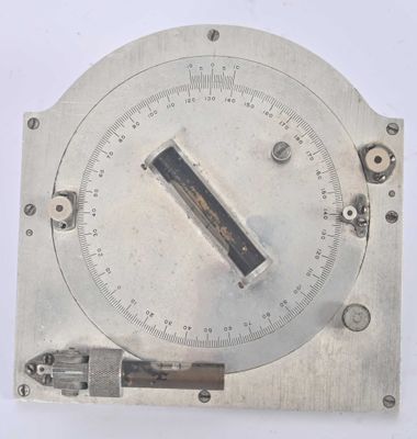a silver clock with a black handle on a white surface