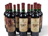 six bottles of wine are lined up in a row on a white surface